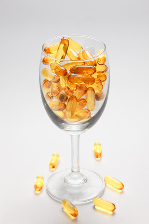 Cod liver oil omega 3 gel capsules isolated on white backgroundの写真素材