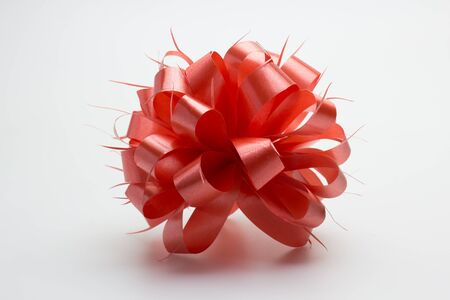 Red ribbon bow isolated on white background.