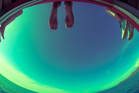 The tourist feet on deck boat background sea for freedom concept.