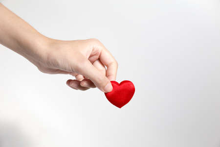 Hand is forwarding red heart shape. For Love Concept and Valentine's Day or Coupleの写真素材