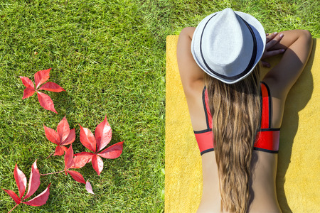 girl lying on the grassの写真素材