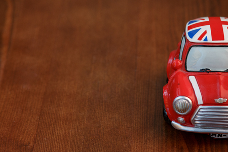 Red Mini Cooper model on wood backgroundの写真素材