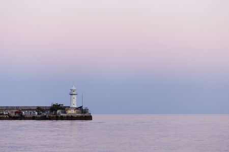 lighthouse and quiet Black Sea in the summer evening, Yalta, Crimea