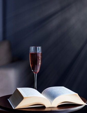 Open book on a wooden table in the living room with a windowの写真素材