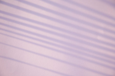 Shadow from blinds on a purple background. selective focus.の写真素材