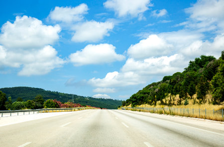 Empty highway in sunny day with blue sky and little white clouds. traffic speed concept