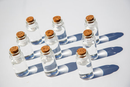 Cardboard Penguin and blue gift box on small dark table against white wall background, party birthday concept, copy space for textの写真素材