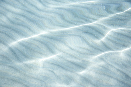 abstract background of the blue sea water and sand rippledの写真素材