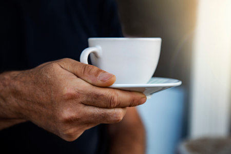 Man holding a cup of coffee in his hand. Selective focus.の写真素材