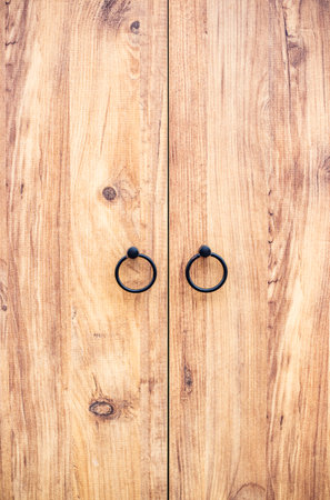 Wooden door with metal rings close-up copy spaceの写真素材