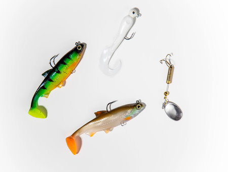 Fishing tackle on a white background. top view colorful silicone fish lures with hooks fishing equipmentの写真素材