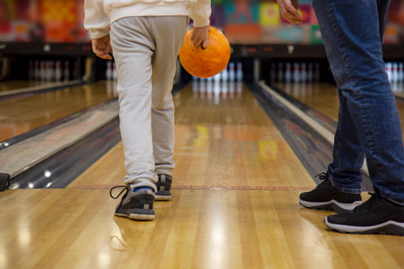 people, leisure, sport and entertainment concept - close up of male friends playing bowling at club