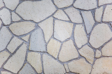 Fragment of a wall from a chipped stone. Abstract background for design.