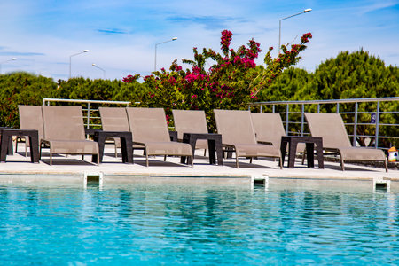 swimming pool with sun loungers in luxury hotel pool resortの写真素材