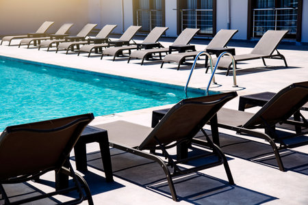 Swimming pool with sunbeds and umbrellas at luxury resortの写真素材