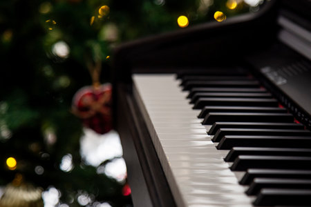 Close up of piano keys with Christmas tree in the background, shallow depth of fieldの写真素材