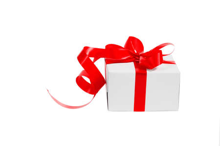 White gift box with red bow isolatedの写真素材