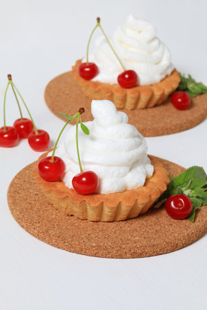 Cake basket with meringue and cherriesの写真素材