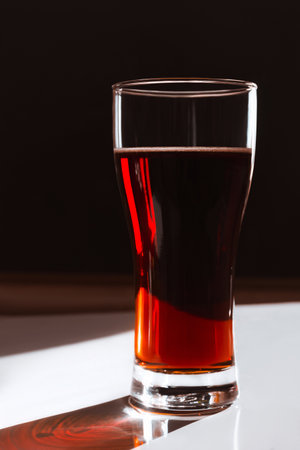 Refreshing drink kvass, beer in a high transparent glass on a black and white backgroundの写真素材