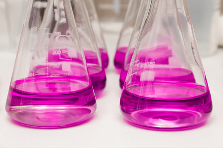 Flasks with liquid colored pink. Chemical analysis, organic test of water in the laboratoryの写真素材