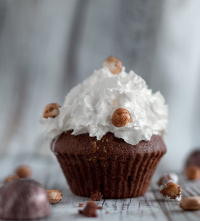 Delicious chocolate brownie muffins with nuts and whipped creamの写真素材