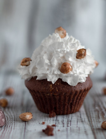 Delicious chocolate brownie muffins with nuts and whipped creamの写真素材