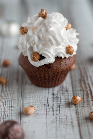Delicious chocolate brownie muffins with nuts and whipped creamの写真素材