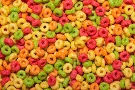 Colored sweet corn rings for the whole frame close-up. A quick, fun and healthy breakfast for childrenの写真素材