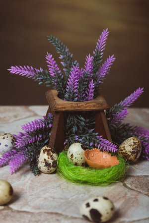 Quail eggs near the nest and lavender flowers on a stone background. Easter Postcardの写真素材