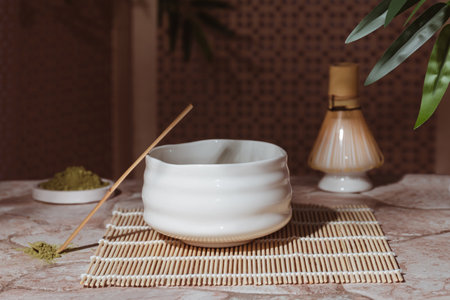 Tea ceremony from the matcha. Tyawan, tyasaku, tyasen on a stone table top among bamboo leavesの写真素材