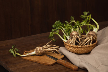 Celery root on a cutting board for slicing into pieces on a wooden background with copy spaceの写真素材