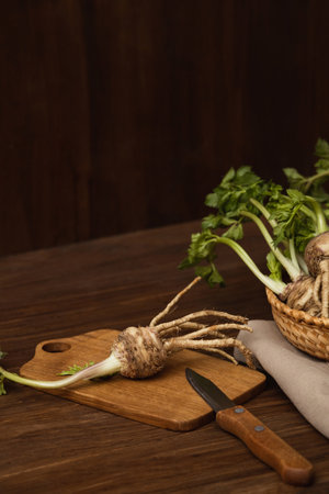 Celery root on a cutting board on a wooden background with copy spaceの写真素材