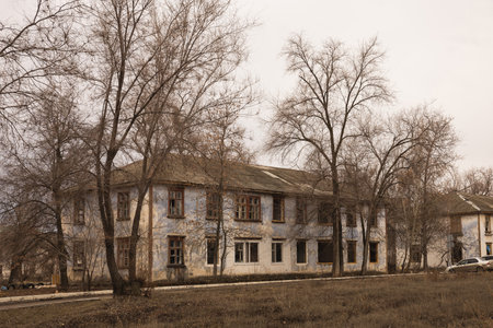 A general view of the street with two storey houses with several apartments for demolition in the spring. Dilapidated housing without tenantsの写真素材