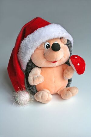 A toy hedgehog decorated for Christmas. Fluffy toy.の写真素材