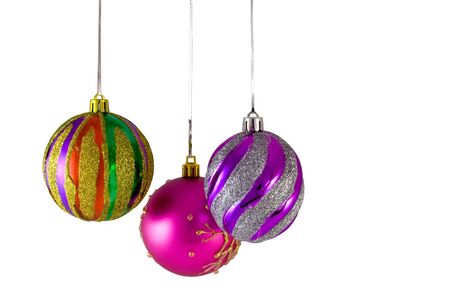 Three Christmas balls hanging over white background.の写真素材