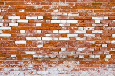 A fragment of old brick wall with white stucco の写真素材