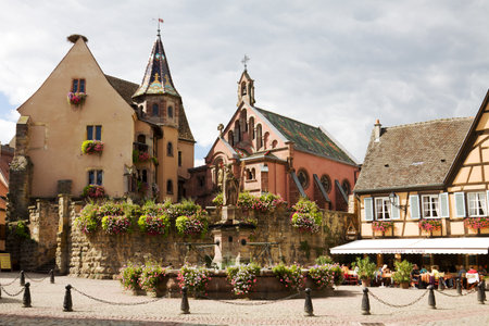 Castle, church and fountain named Saint Leon on the central square of Eguisheim village in France. Eguisheim is a commune in Alsace in north-eastern France. Since 2003 Eguisheim is included into the list of the most beautiful villages of France.のeditorial素材