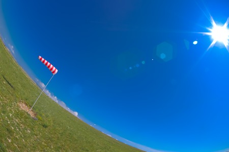 windsock at the airport shows wind direction, photographed by fisheyeの写真素材