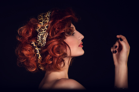 Portrait of Beautiful Woman in studio with dangerous snake.  In Greek mythology Medusa was a monsterの写真素材