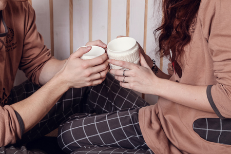 young happy smiling casual couple. warm light. morning after Christmas, in pajamasの写真素材