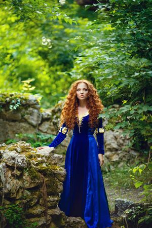 Brave. Merida from Brave film. Beautiful red-haired girl in the costume of the heroine of the animated filmの写真素材