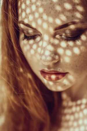 Portrait of a charming young woman outdoor. Light and shadow. interesting portait of young girl's...