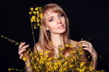 beautiful smiling girl with flowers in her hairの写真素材