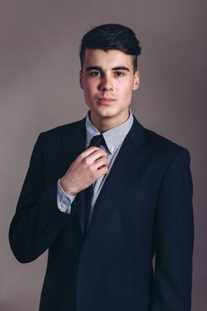 Portrait of handsome stylish man in elegant black suitの写真素材