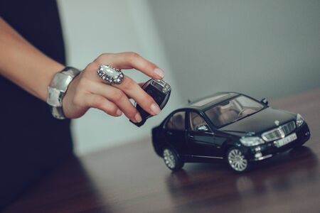 Manicured Female Hand Playing With Toy Car.の写真素材