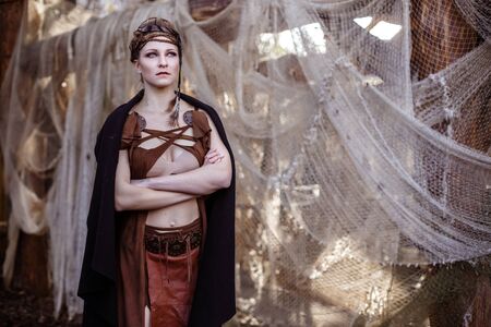 Viking woman with sword and shield in a traditional warrior clothes.の写真素材