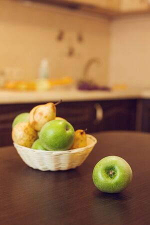 Young beautiful woman in checkered blue shirt and shorts making pie with apples and tea with lime and cinnamon at the vintahe kitchen. Seriesの写真素材