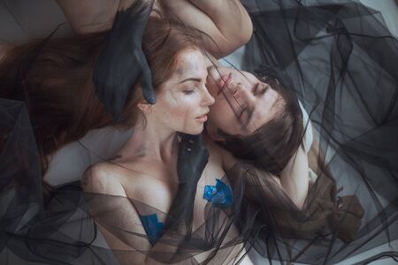 mystical couple beauty portrait with veil, studio shot, closeupの写真素材