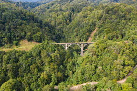 Old miners railway bridge in the mountains and forests. Tkuarchal, Akarmara, Abkhazia, Georgiaの写真素材