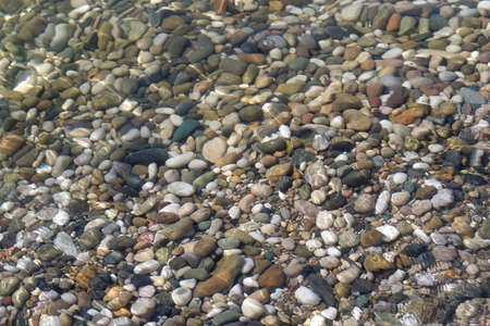 small sea pebbles in the water. Smooth stonesの写真素材